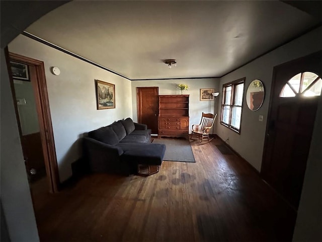 living area with arched walkways and wood finished floors