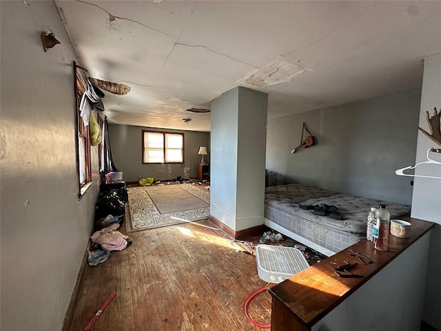 interior space with wood-type flooring and baseboards