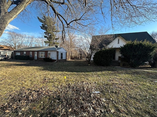 view of side of home with a lawn