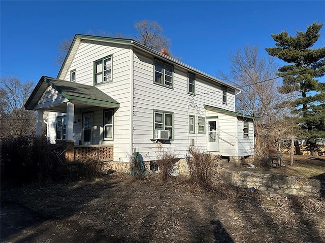 view of home's exterior with a porch and cooling unit