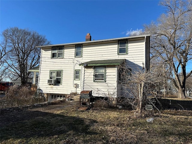 rear view of house featuring a chimney