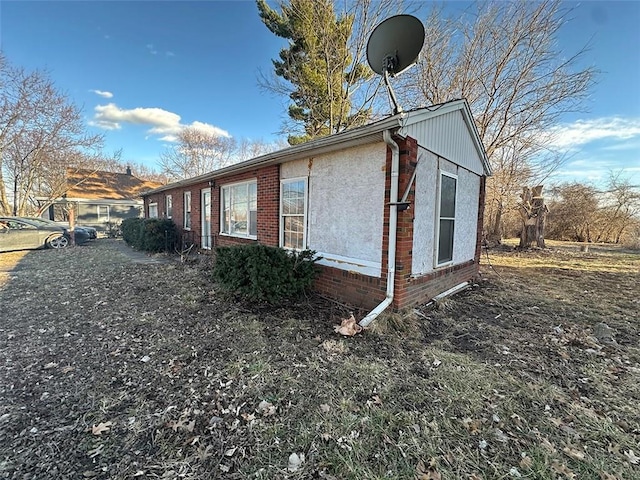 view of side of property with brick siding