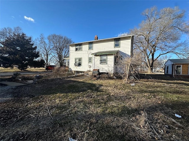 rear view of house with a chimney