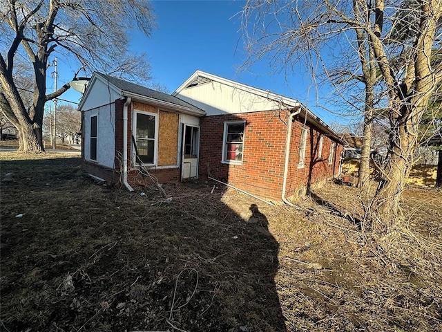 view of side of property featuring brick siding