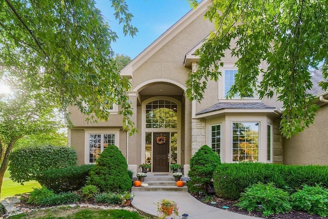 entrance to property with stucco siding