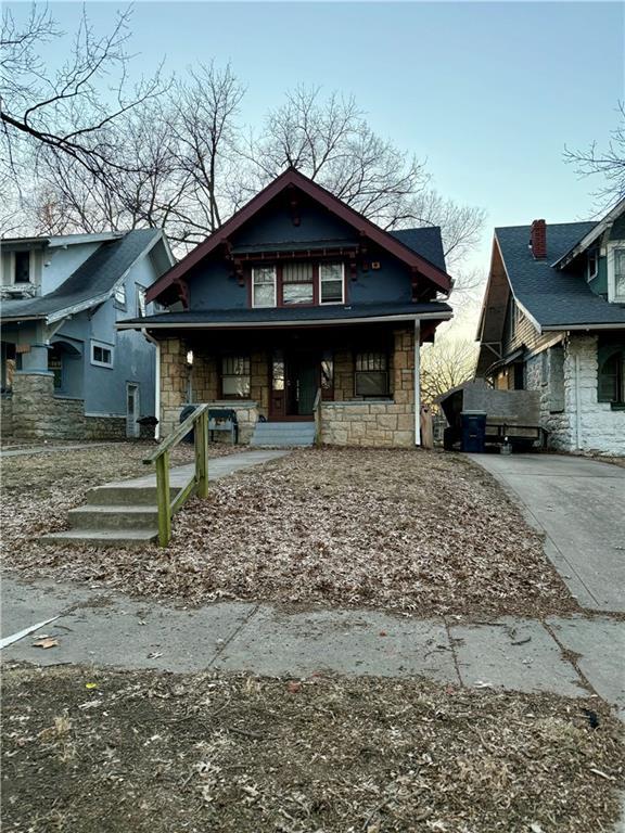 view of front of home featuring stone siding and covered porch