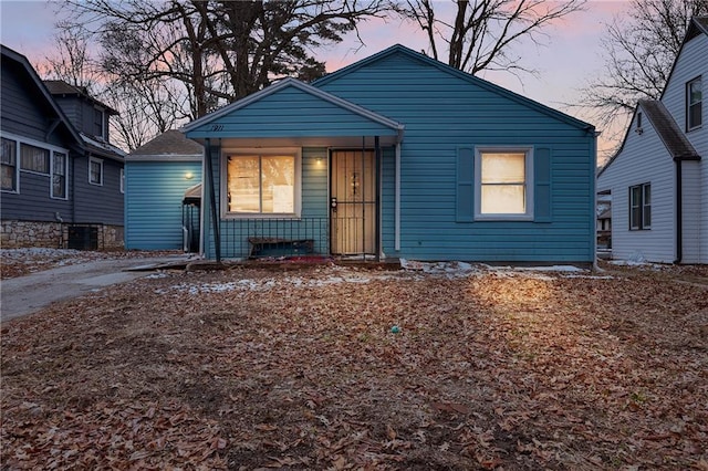 bungalow-style house with central air condition unit and covered porch