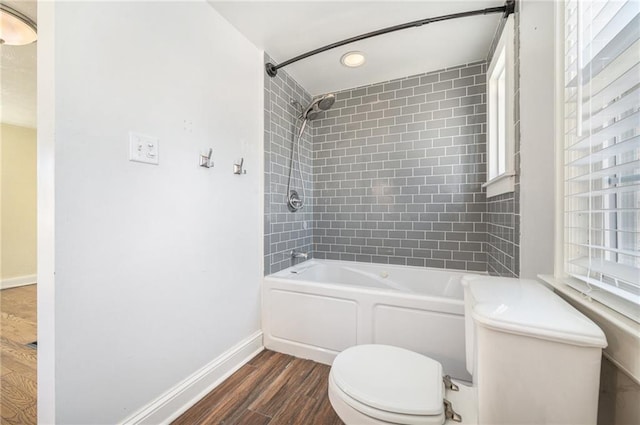 full bath with toilet, baseboards, tub / shower combination, and wood finished floors