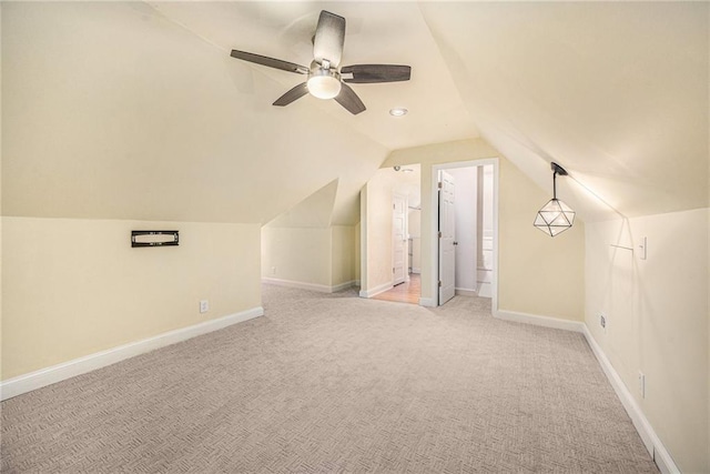 bonus room with light carpet, lofted ceiling, and baseboards