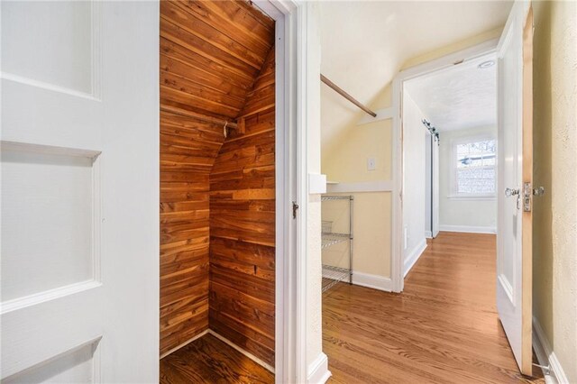 interior space featuring baseboards and wood finished floors