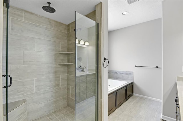 full bath featuring a garden tub, a shower stall, visible vents, and baseboards