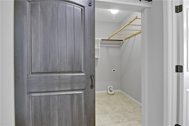 laundry room with laundry area, hookup for an electric dryer, and baseboards