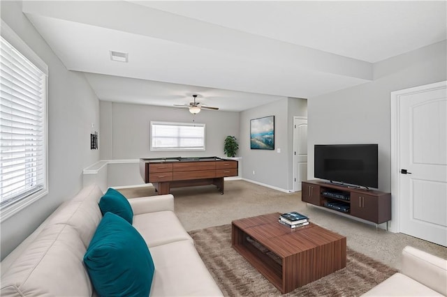 carpeted living area with visible vents, ceiling fan, and baseboards