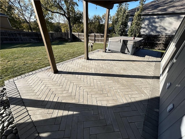 view of patio / terrace with a hot tub and a fenced backyard