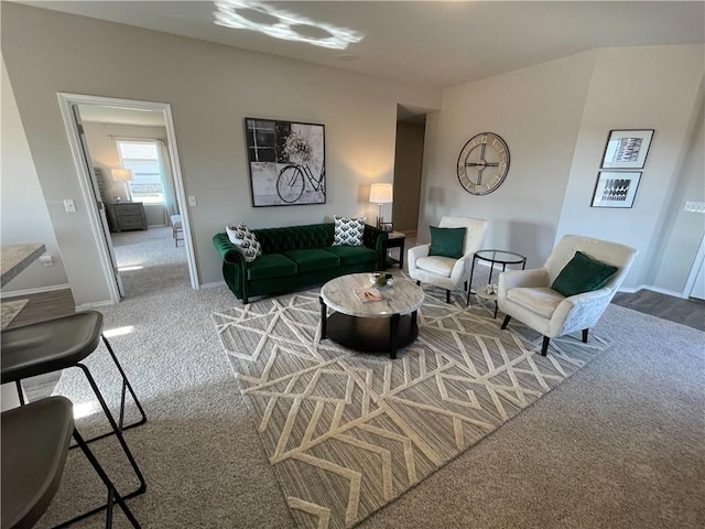 carpeted living area with baseboards