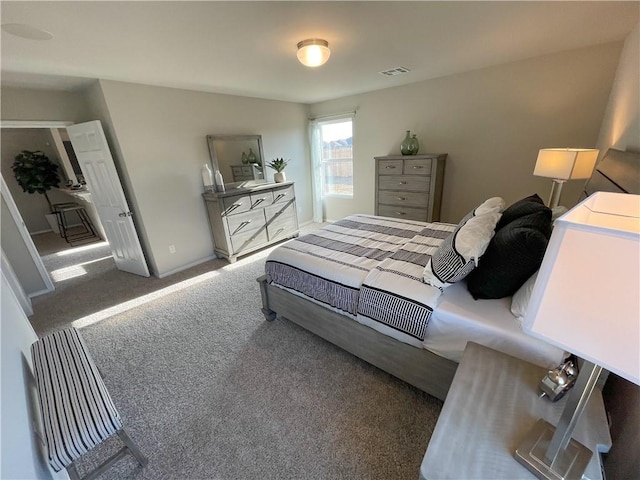 bedroom with baseboards, visible vents, and carpet flooring