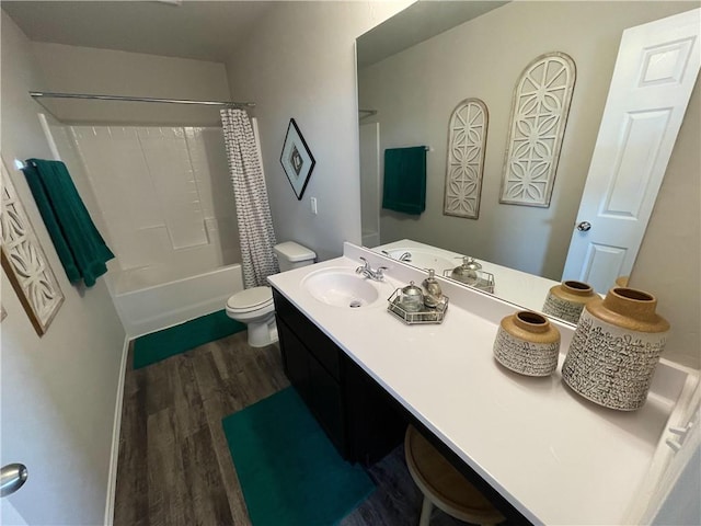 bathroom featuring toilet, shower / tub combo with curtain, wood finished floors, and vanity