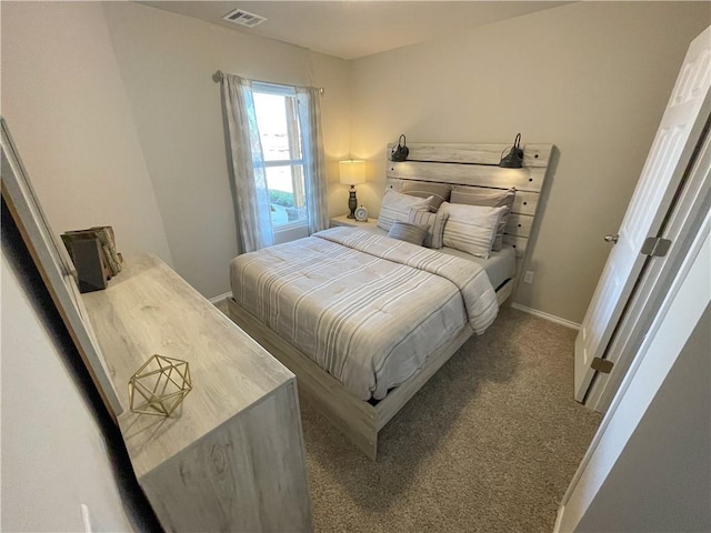 carpeted bedroom with visible vents and baseboards