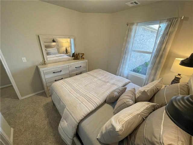 bedroom with carpet floors, baseboards, and visible vents