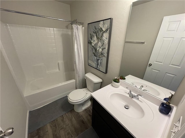 bathroom with vanity, wood finished floors, toilet, and shower / bathtub combination with curtain