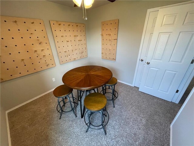 dining area with baseboards and carpet flooring