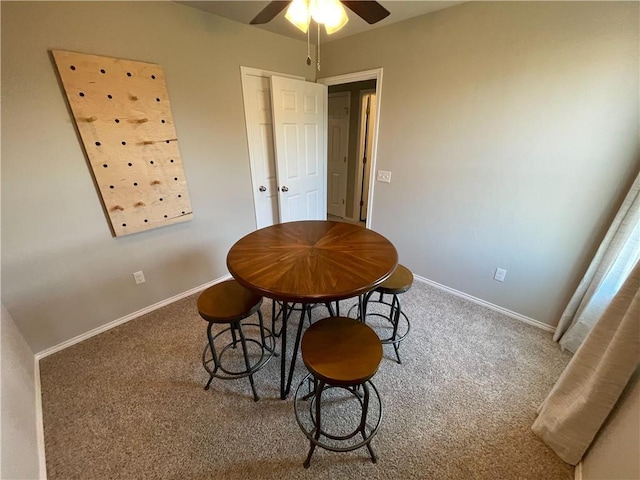 dining area featuring carpet floors, ceiling fan, and baseboards