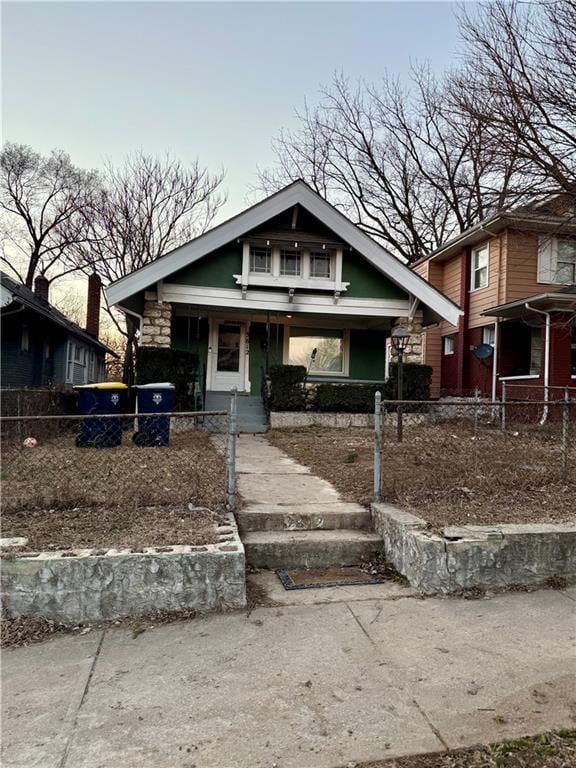 view of front of home with a porch and a fenced front yard