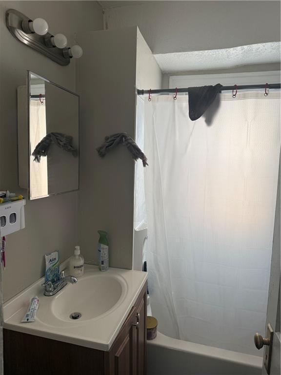 full bathroom with vanity and shower / tub combo with curtain