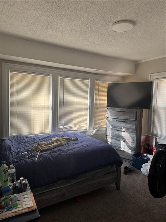 carpeted bedroom featuring a textured ceiling