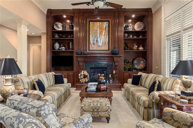living area featuring ornate columns, a ceiling fan, built in features, and light carpet