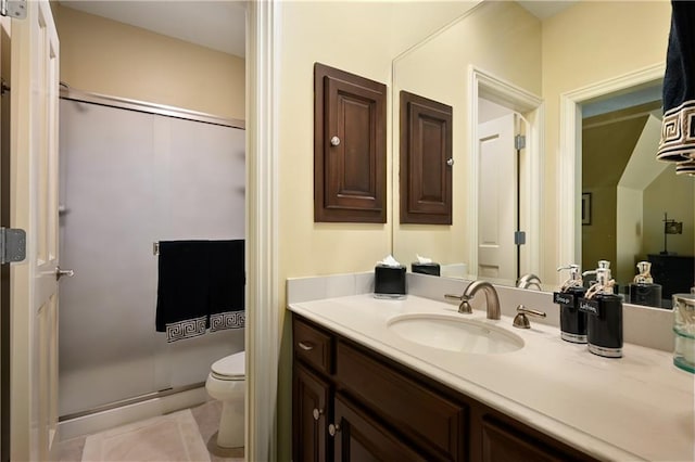 bathroom featuring vanity, tile patterned floors, a shower stall, and toilet