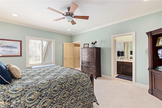 bedroom with a ceiling fan, crown molding, baseboards, light carpet, and ensuite bath