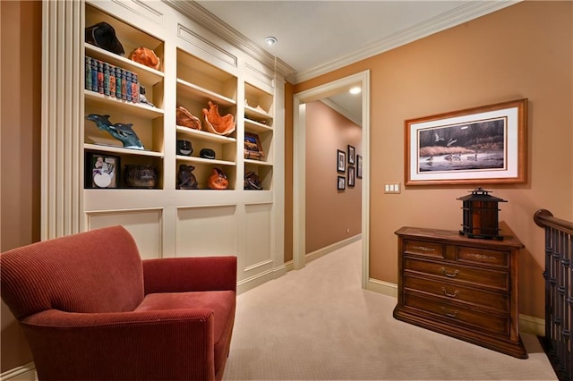 living area with carpet floors, baseboards, and ornamental molding