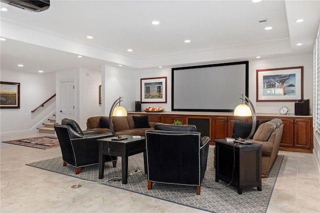 home theater room with recessed lighting, a tray ceiling, visible vents, and ornamental molding