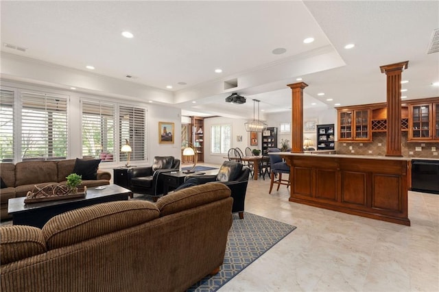 living room with crown molding, recessed lighting, decorative columns, and visible vents