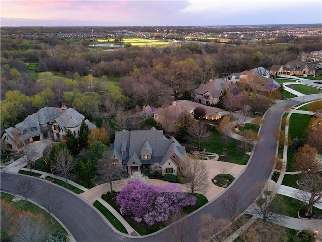 aerial view at dusk featuring a residential view