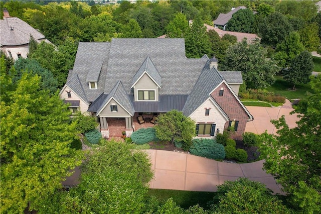 10816 W 140th St, Overland Park, KS 66221 - view of front facade with a standing seam roof, stone siding, metal roof, and a shingled roof