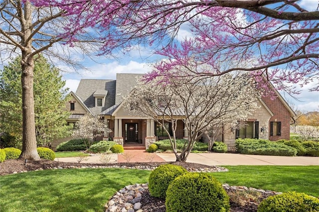 10816 W 140th St, Overland Park, KS 66221 - craftsman-style home with stone siding and a front lawn