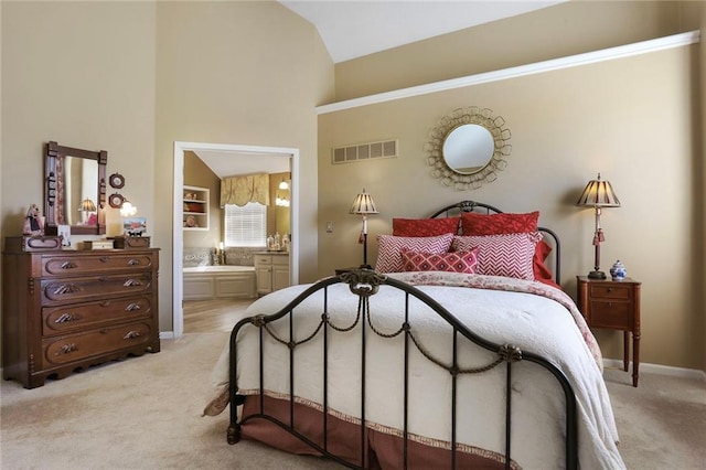 bedroom featuring light carpet, visible vents, ensuite bath, and baseboards