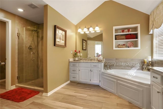 full bathroom featuring wood tiled floor, a bath, visible vents, and a stall shower