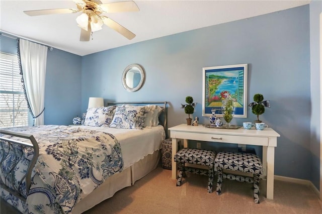 bedroom with a ceiling fan, carpet, and baseboards