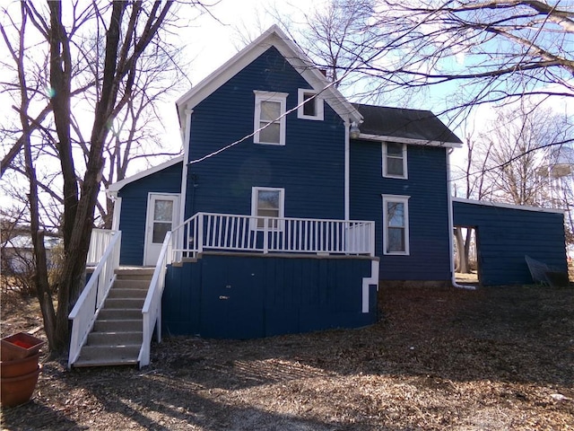 view of front of property featuring stairway and a wooden deck