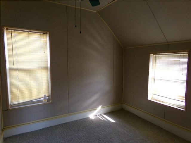 additional living space with lofted ceiling, carpet floors, and a ceiling fan