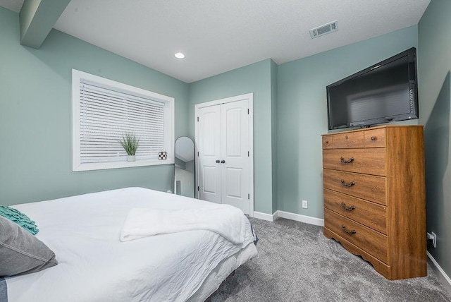 carpeted bedroom with recessed lighting, baseboards, visible vents, and a closet