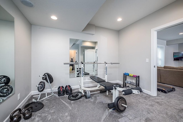 workout room with recessed lighting, a textured ceiling, and baseboards