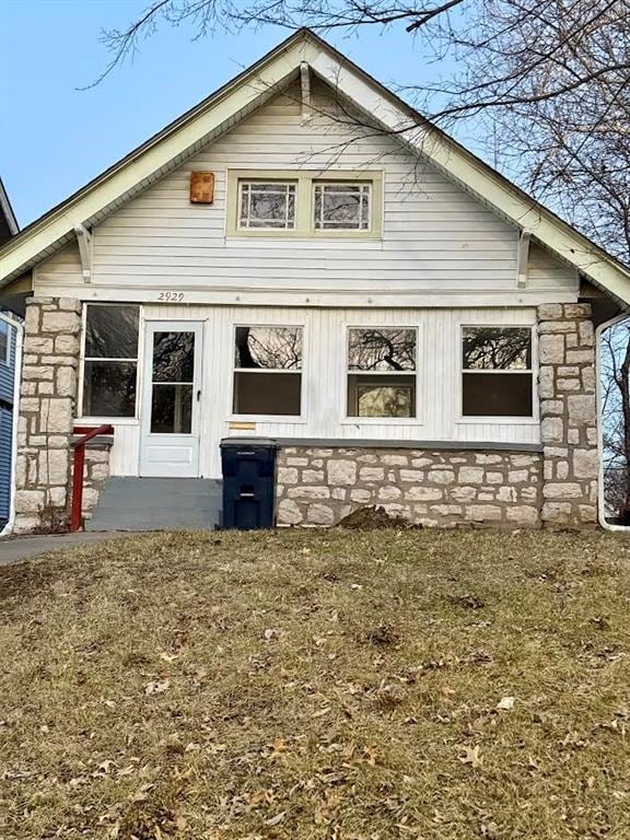 view of side of property with stone siding