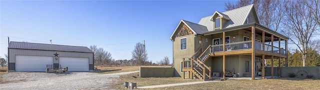 back of property featuring dirt driveway, an outdoor structure, and stairs