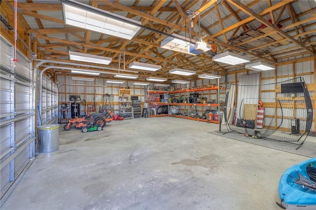 garage with a workshop area, a garage door opener, and metal wall