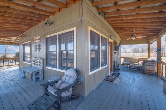 wooden deck featuring a ceiling fan