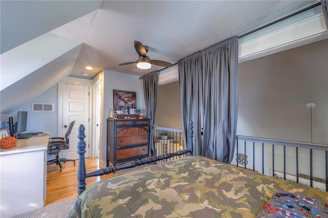 bedroom featuring a ceiling fan, wood finished floors, visible vents, recessed lighting, and a textured ceiling